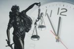Lady Justice in front of a clock
